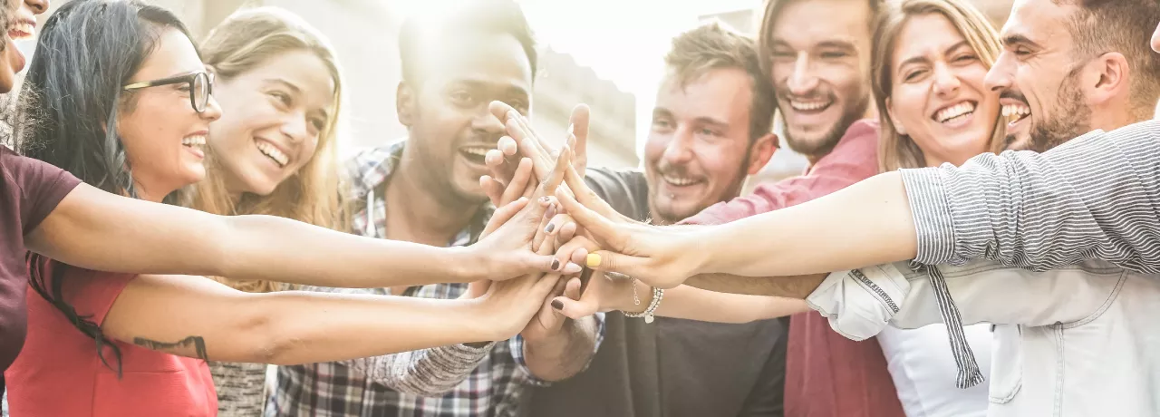 An image showing a team putting their hands together