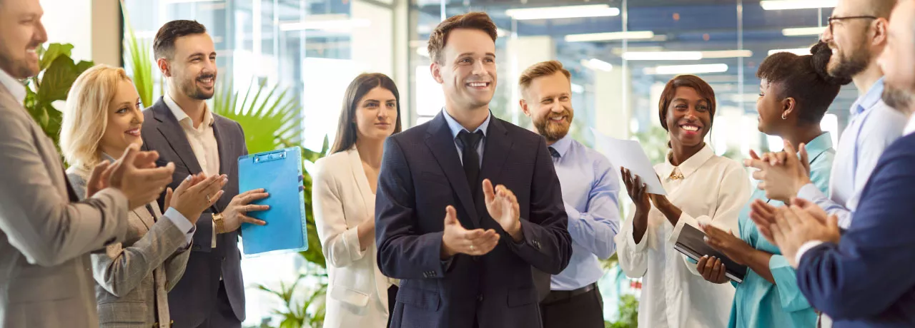 A group of employees celebrating with one another in the office