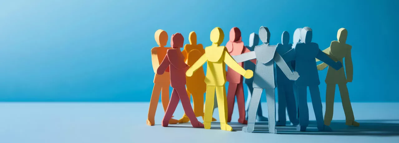 Paper stick figures huddled in a group